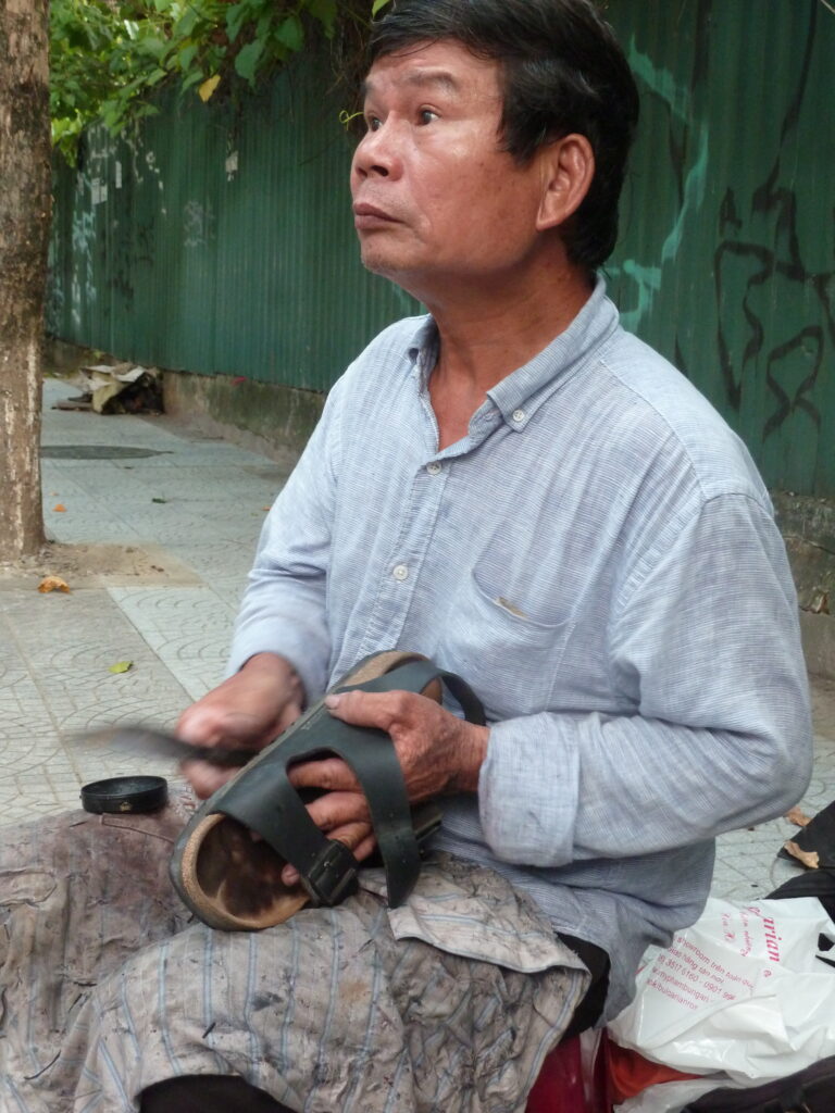 Vietnam shoemaker at work, Birkenstock perfectly restored