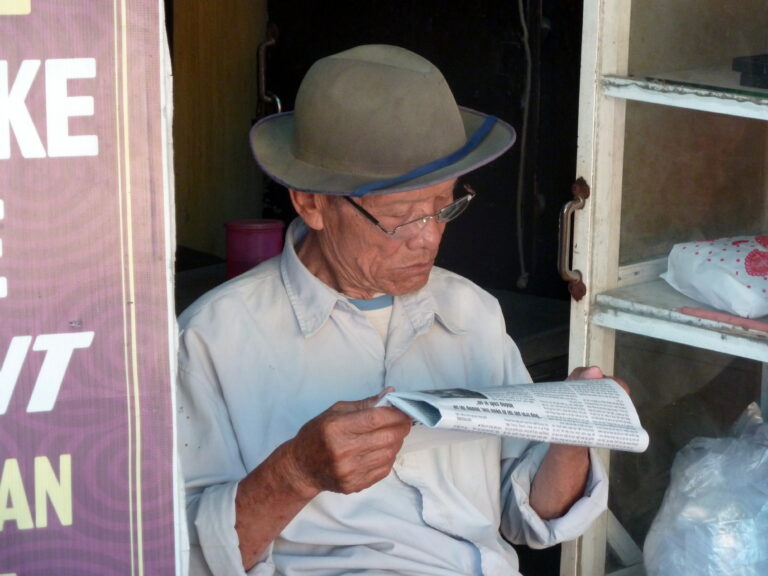 Hội An, Quảng Nam, Vietnam, reading his news papaer