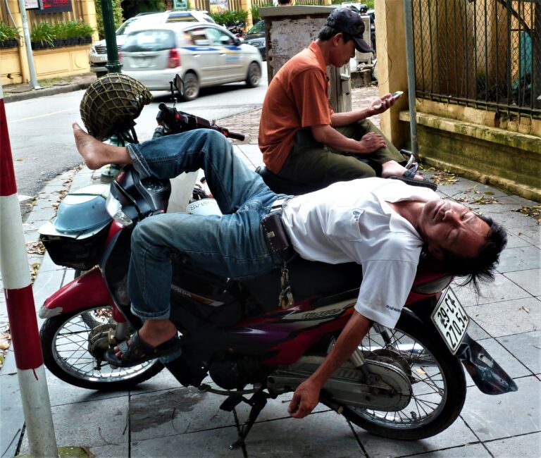 Hanoi Vietnam exhausted by the heat of the middle of the day nothing could disturb this man