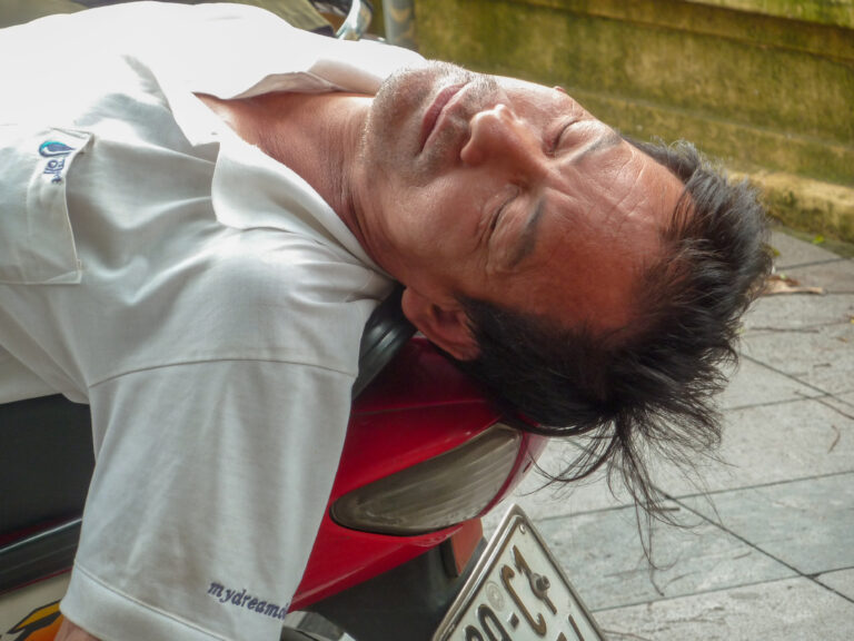 Hanoi Vietnam exhausted by the heat of the middle of the day nothing could disturb this man